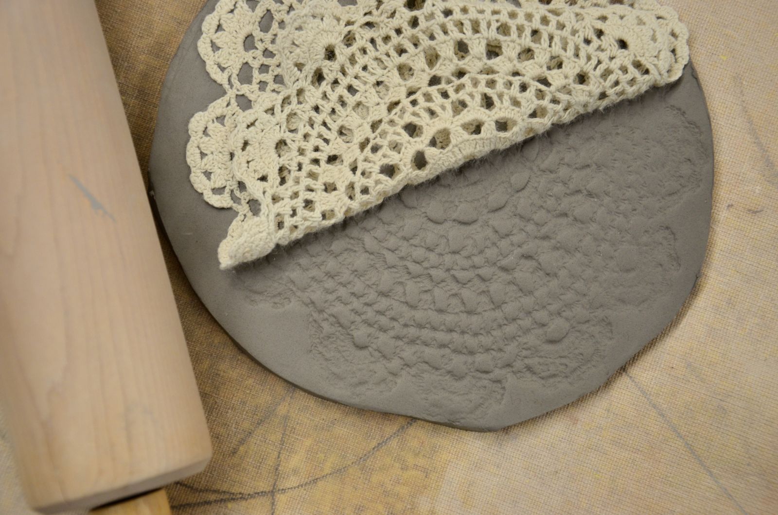 Using a doily to create texture in clay