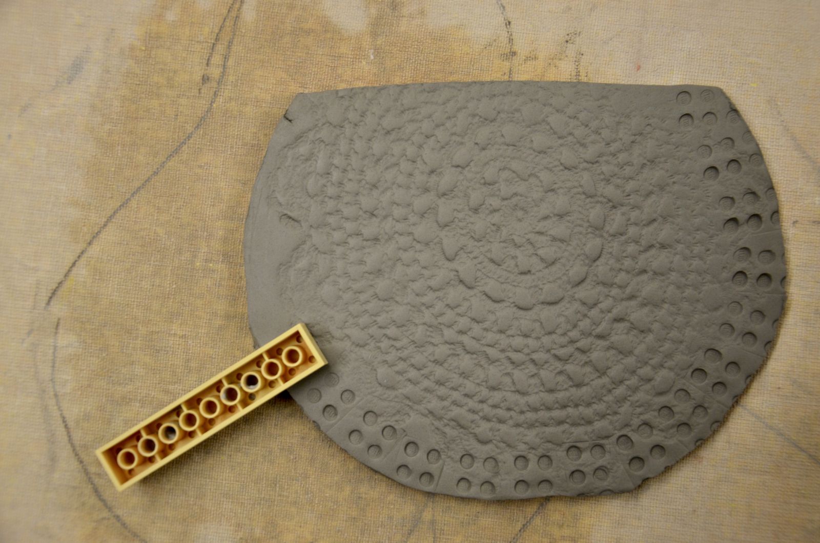 Using a lego to create texture in clay slab